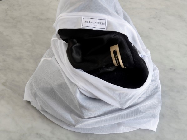 Detachable coat items like a faux fur lining or a hood are safely laundered in The Laundress Mesh Wash Bag.