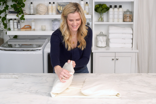 Woman folding sheets